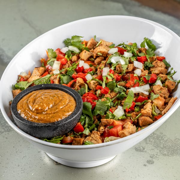 Raging Burrito's chicken burrito bowl with salsa, cilantro, tomatoes, and onions.
